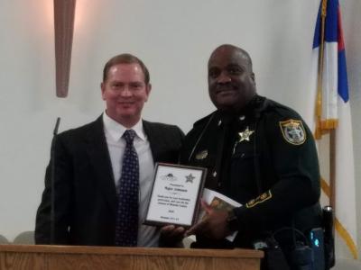 Major Johnson accepting certificate of appreciation